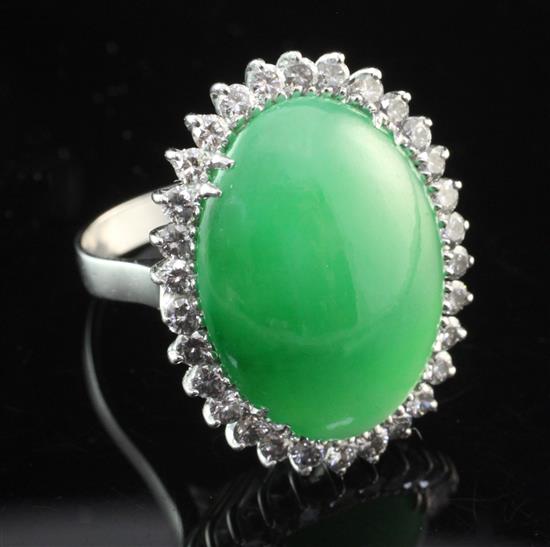 A white gold, cabochon jadeite and diamond ring, size M.